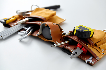 Image showing different work tools in belt on white background