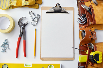 Image showing clipboard with white paper, pencil and work tools