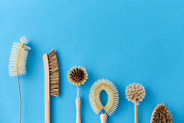 Image showing different cleaning brushes on blue background