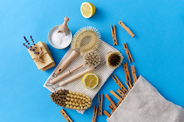 Image showing cleaning brushes, lemon and wooden clothespins