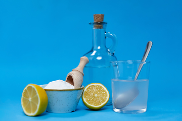 Image showing lemons, washing soda, bottle of vinegar and glass