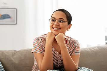 Image showing african american woman in glasses sitting on sofa