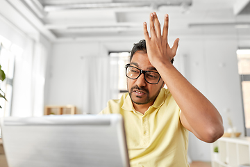 Image showing stressed man with laptop working at home office