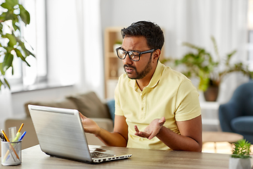 Image showing sad man with laptop working at home office