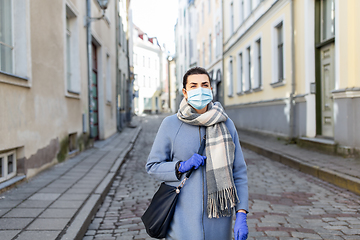 Image showing woman wearing medical mask and gloves in city