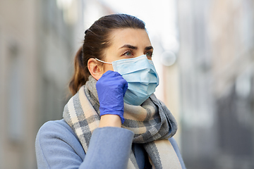 Image showing young woman wearing protective medical mask