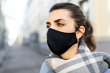 Image showing woman wearing protective reusable mask in city