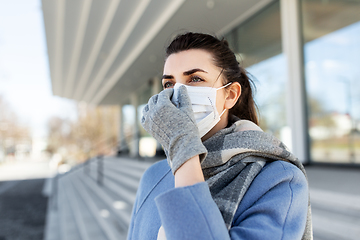 Image showing woman wearing protective medical mask in city