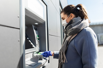 Image showing woman in medical mask and glove with money at atm