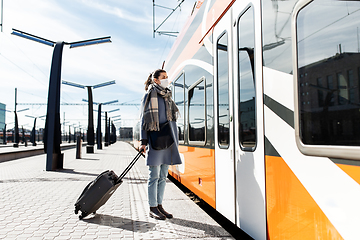 Image showing woman in protective face mask at railway station