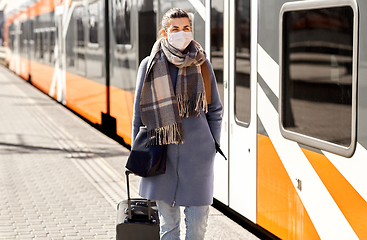 Image showing woman in protective face mask at railway station