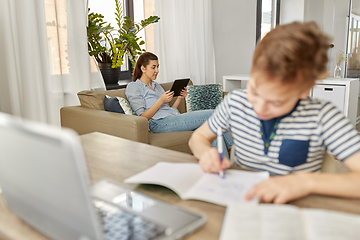 Image showing mother with tablet pc and son learning at home