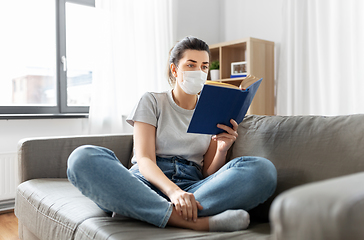 Image showing sick woman in medical mask reading book at home