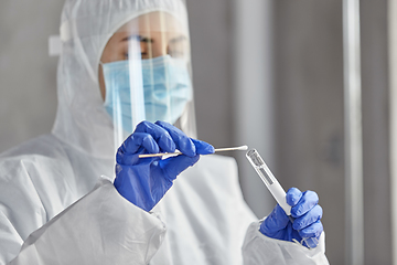 Image showing scientist holding beaker with coronavirus test