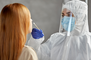 Image showing doctor in protective wear making coronavirus test