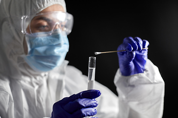 Image showing scientist holding beaker with coronavirus test