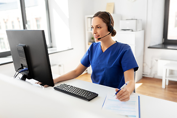 Image showing doctor with headset and computer at hospital