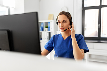 Image showing doctor with headset and computer at hospital