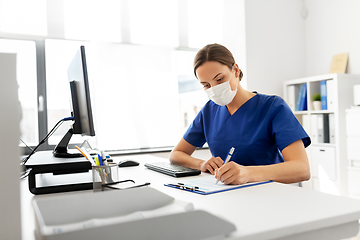 Image showing doctor or nurse in mask with clipboard at hospital