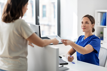 Image showing doctor and patient with prescription at hospital