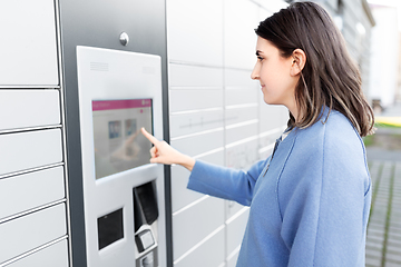 Image showing woman using outdoor automated parcel machine