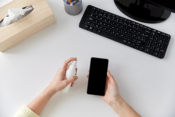 Image showing close up of woman cleaning smartphone