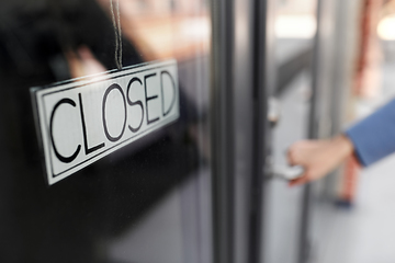 Image showing hand trying to open closed office door