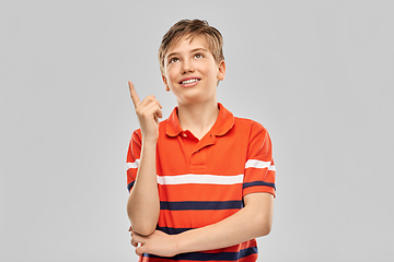 Image showing portrait of happy smiling boy pointing finger up