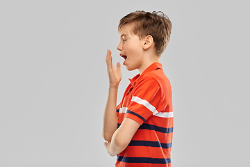 Image showing portrait of tired yawning boy in red polo t-shirt