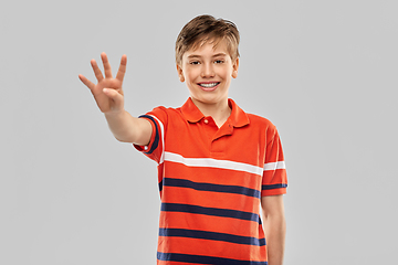 Image showing portrait of happy smiling boy showing four fingers