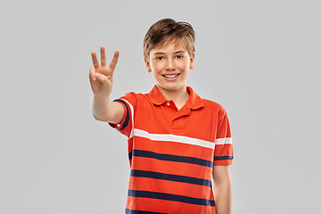 Image showing portrait of smiling boy showing three fingers