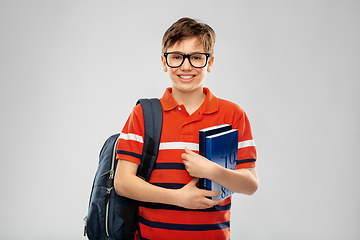 Image showing smiling student boy with backpack and books