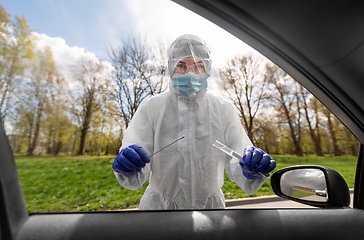 Image showing healthcare worker making coronavirus test at car