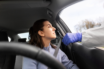 Image showing healthcare worker making coronavirus test at car