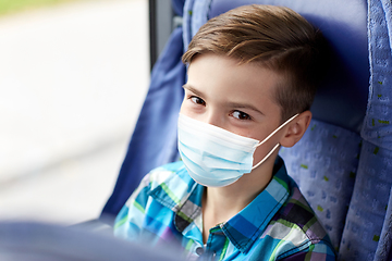 Image showing boy in mask sitting in travel bus or train