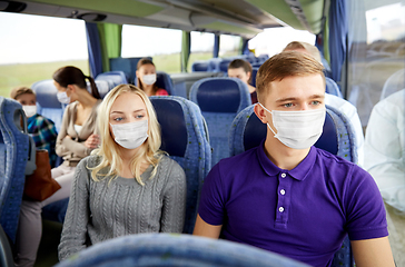 Image showing couple or passengers in masks in travel bus