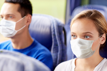 Image showing young woman in mask sitting in travel bus or train