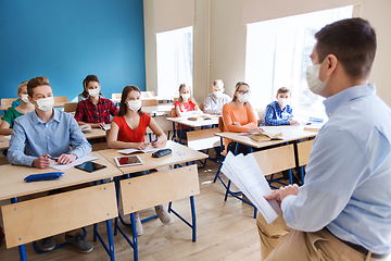 Image showing group of students in masks and teacher at school