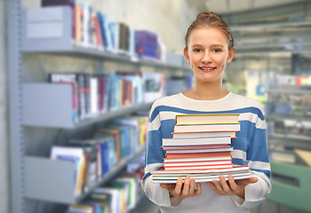 Image showing smiling teenage student girl with books at library