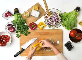 Image showing hands preparing pepper for salad at kitchen