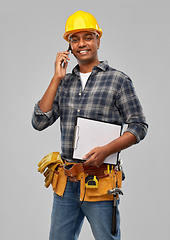 Image showing indian builder in helmet calling on smartphone