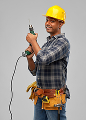 Image showing happy indian builder in helmet with electric drill