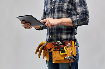 Image showing male builder with tablet pc and working tools