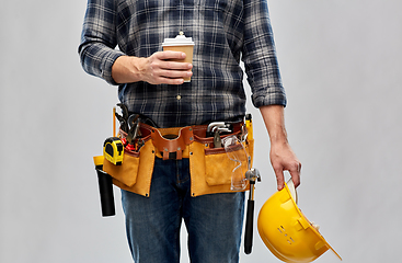 Image showing male builder with coffee, helmet and working tools