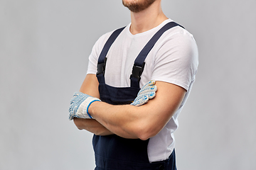 Image showing close up of male builder in overall and gloves