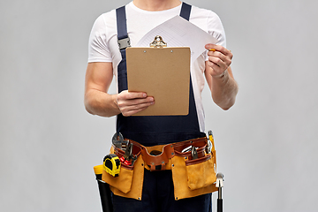 Image showing builder with clipboard, pencil and working tools