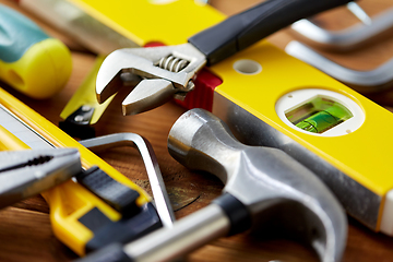 Image showing different work tools on wooden boards background