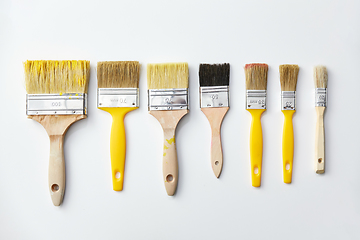 Image showing different size paint brushes on white background