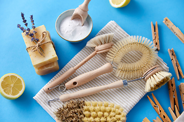 Image showing cleaning brushes, lemon and wooden clothespins