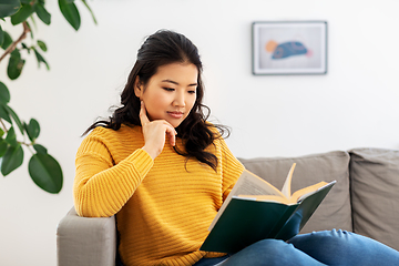 Image showing asian young woman reading book at home